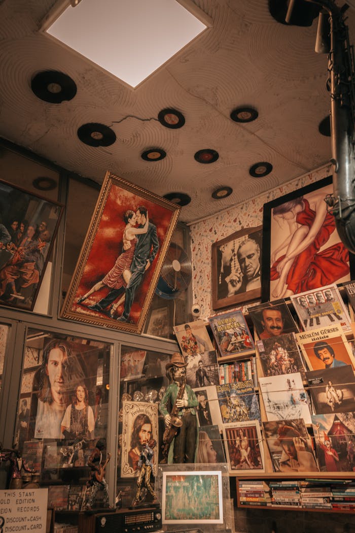 A cozy vintage store corner filled with posters, vinyl records, and framed art.